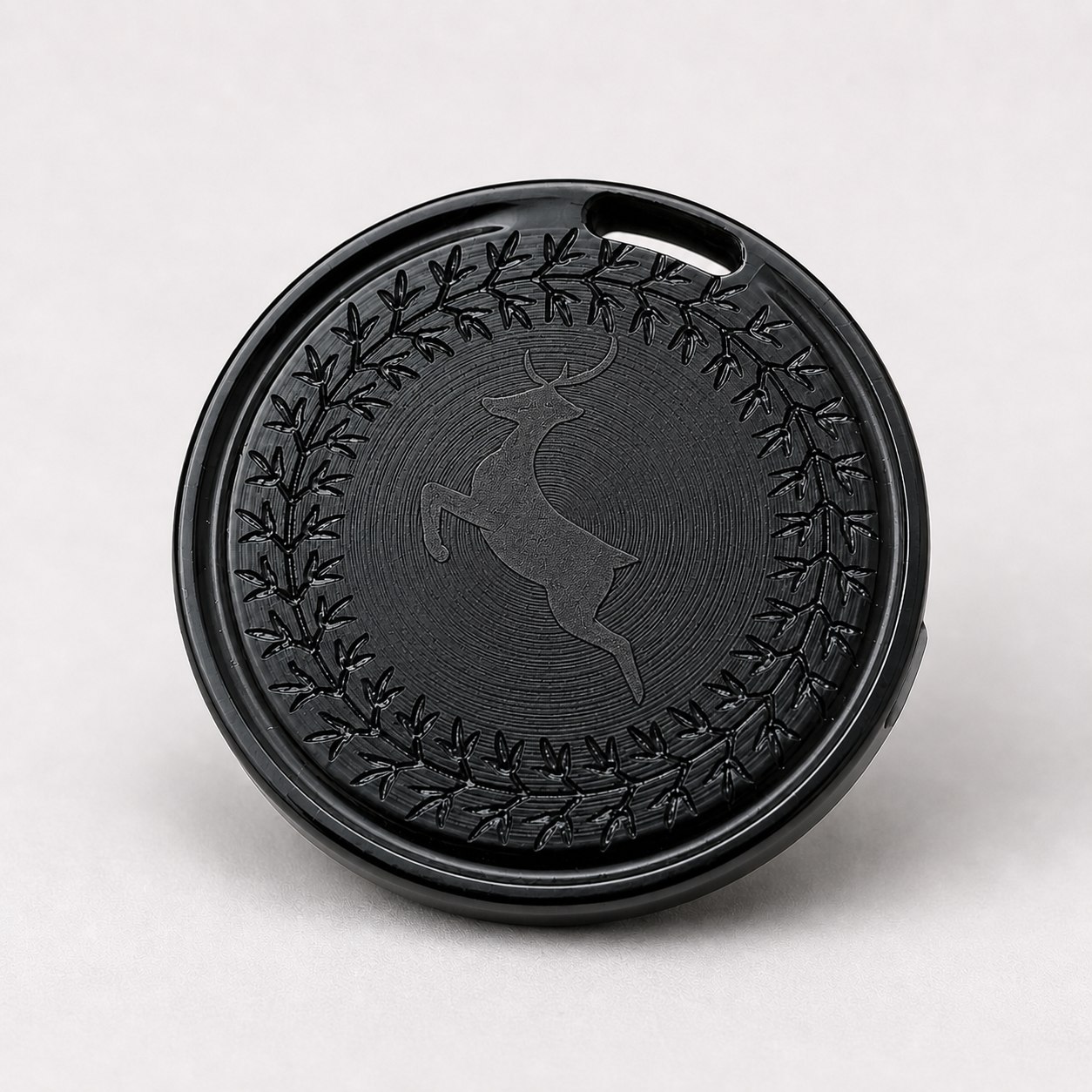 OTAG tracker engraved with a deer and laurel wreath design